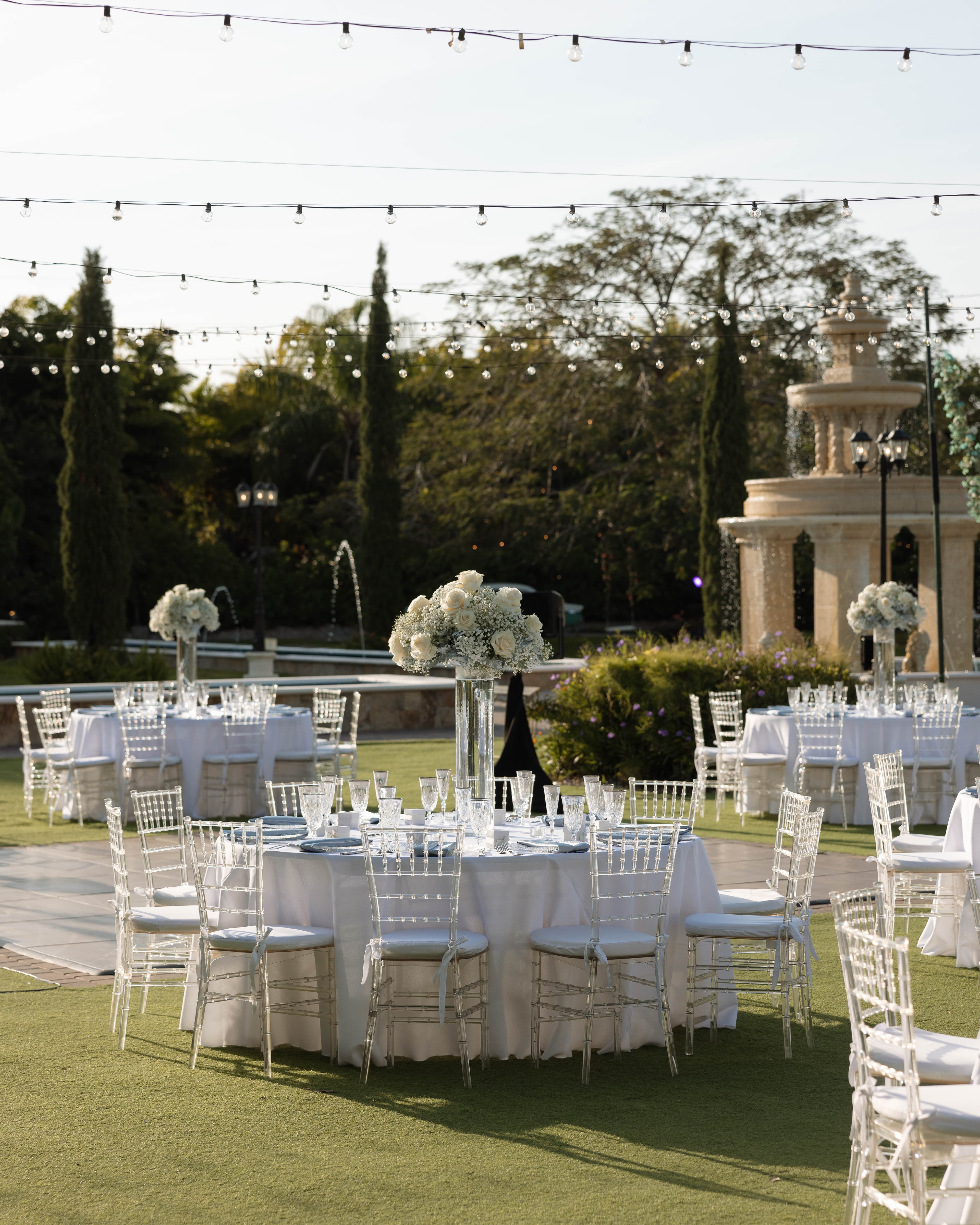 Outdoor reception with string lights and chiavari chairs
