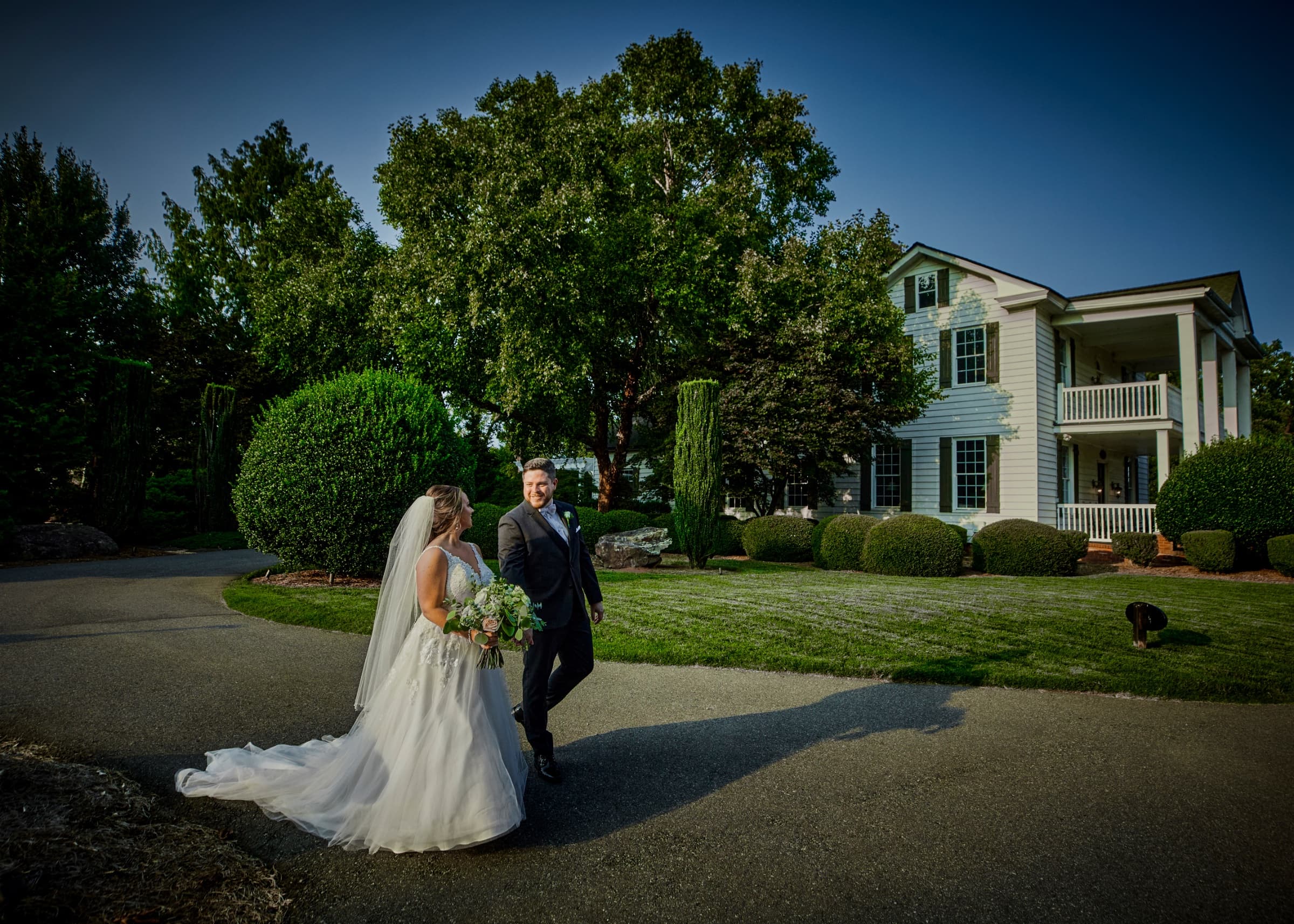 Couple on the drive in front of the white plantation house — Langtree Plantation wedding venue, Mooresville, North Carolina