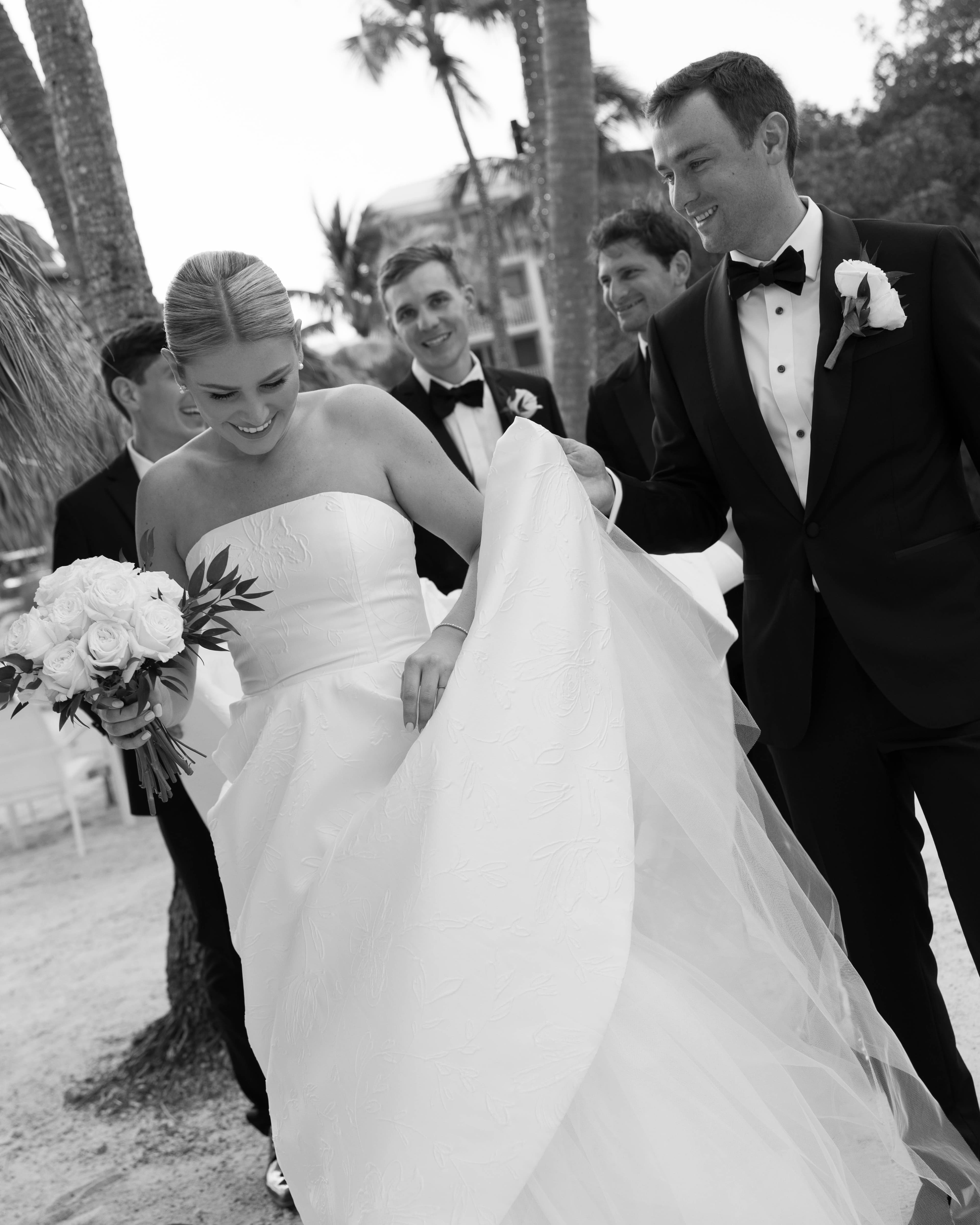 Bride and groom walking with bridal party — Ocean Reef Club, Key Largo